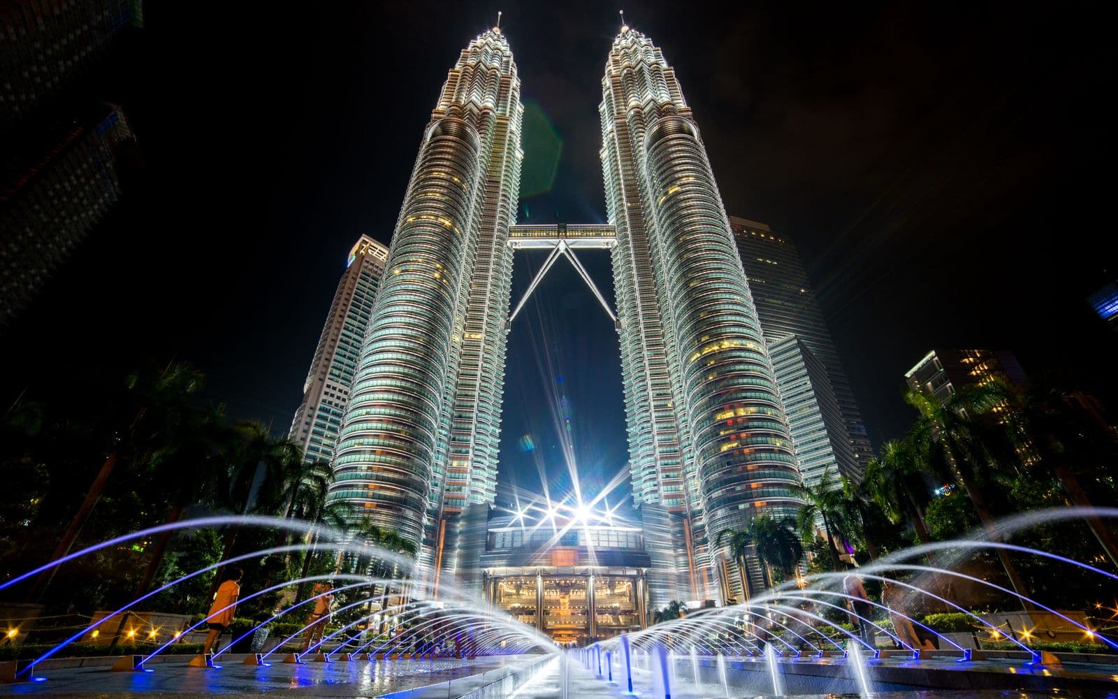 Illuminated Petronas Twin Towers at night with fountains in the foreground, Kuala Lumpur